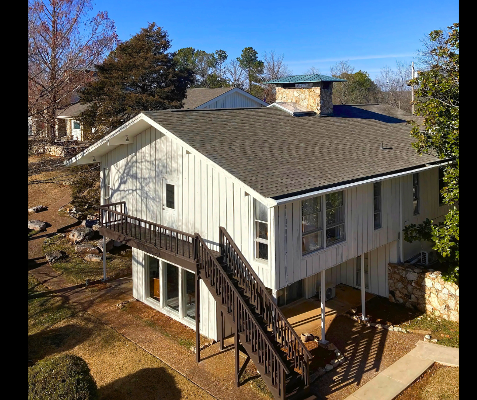 Exterior of a two-story guest house with a metal staircase.