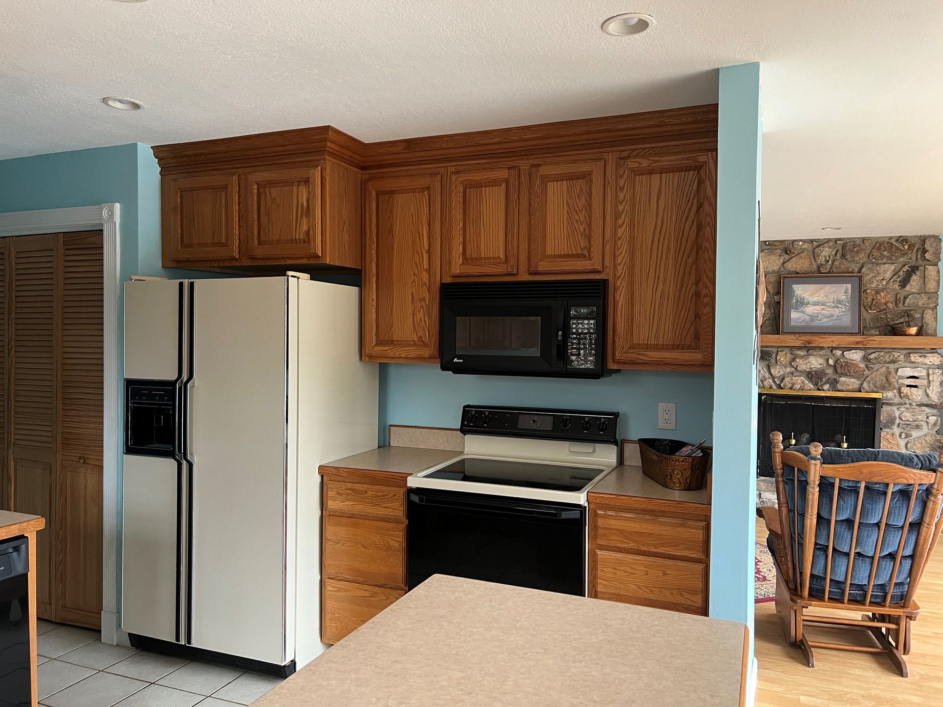 A kitchen with a refrigerator stove and microwave