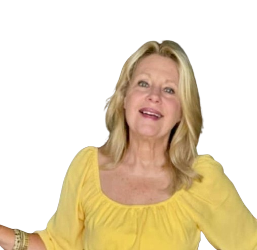 Woman with blonde hair, smiling, wearing a yellow top. Indoors, neutral background.