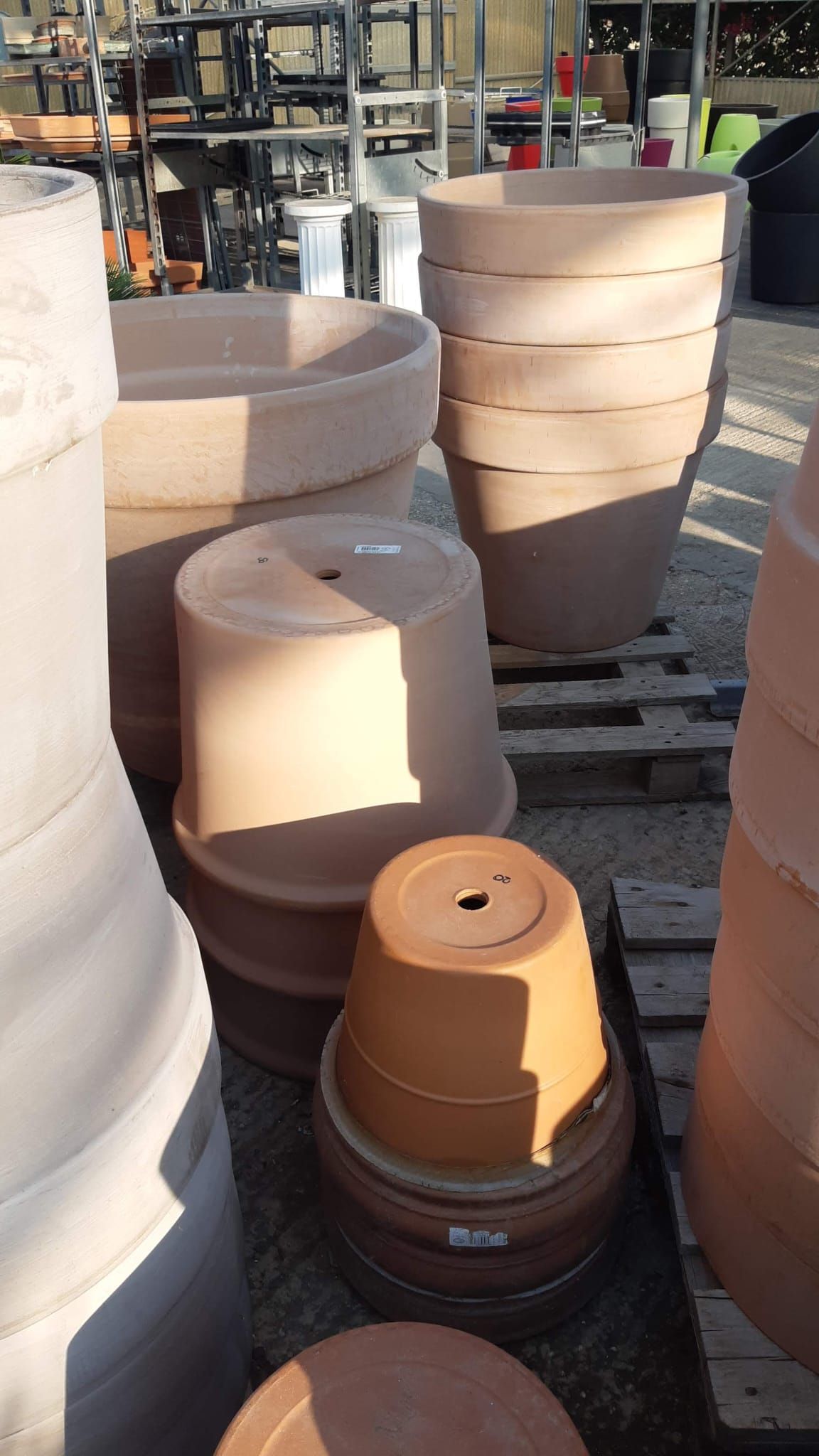 Vari vasi di terracotta per piante accatastati all'esterno.