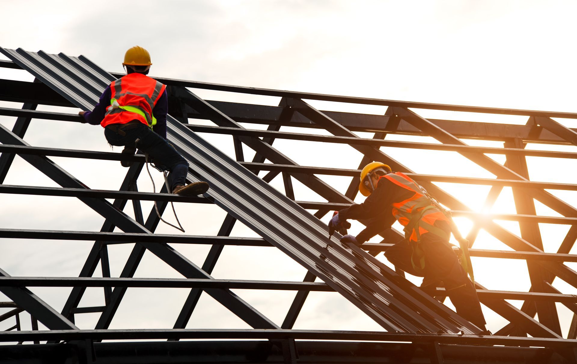 Two Construction Workers Are Working on the Roof of a Building