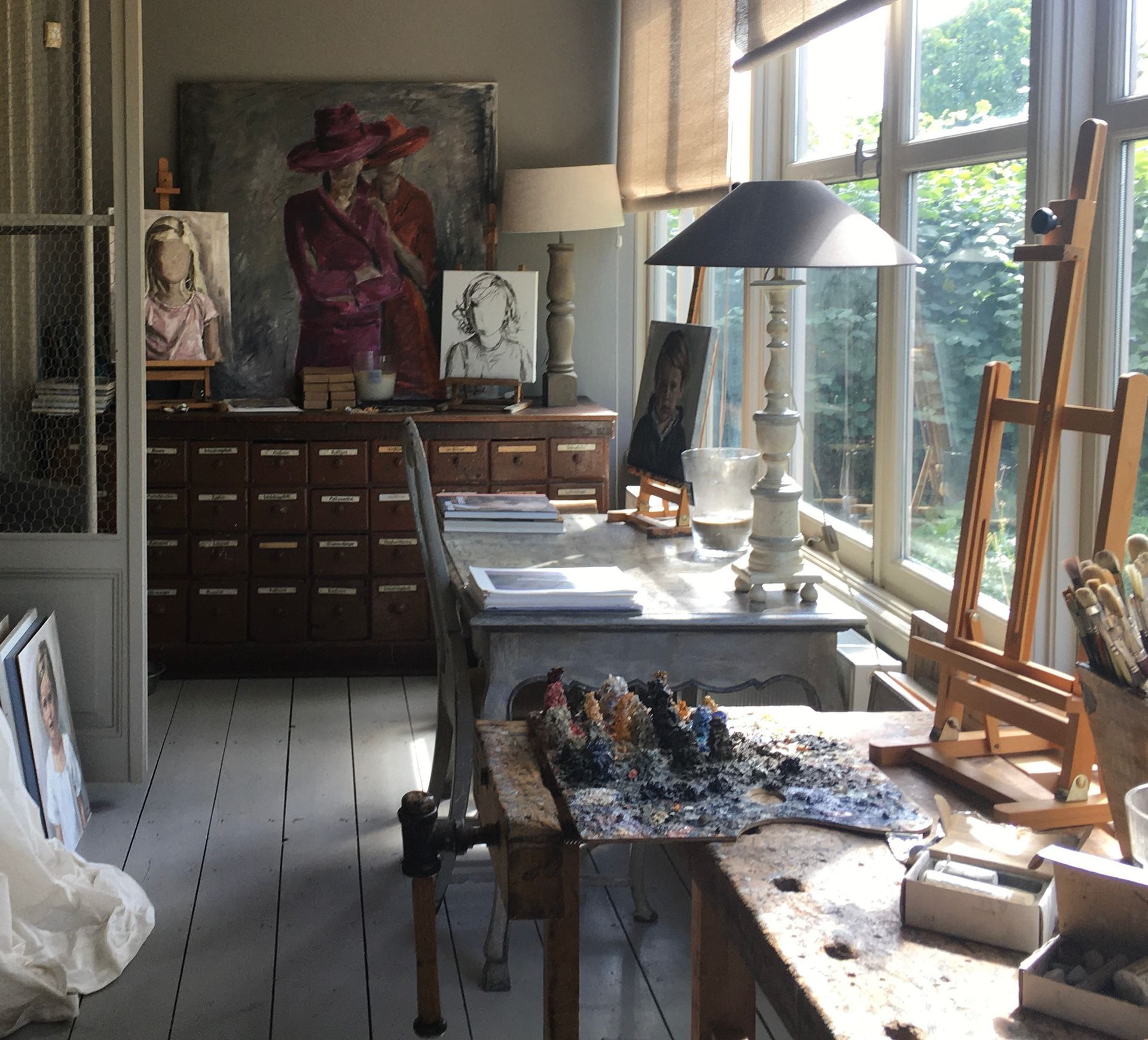 Een kunstenaarsatelier met een schilderij aan de muur. atelier rianne smit.