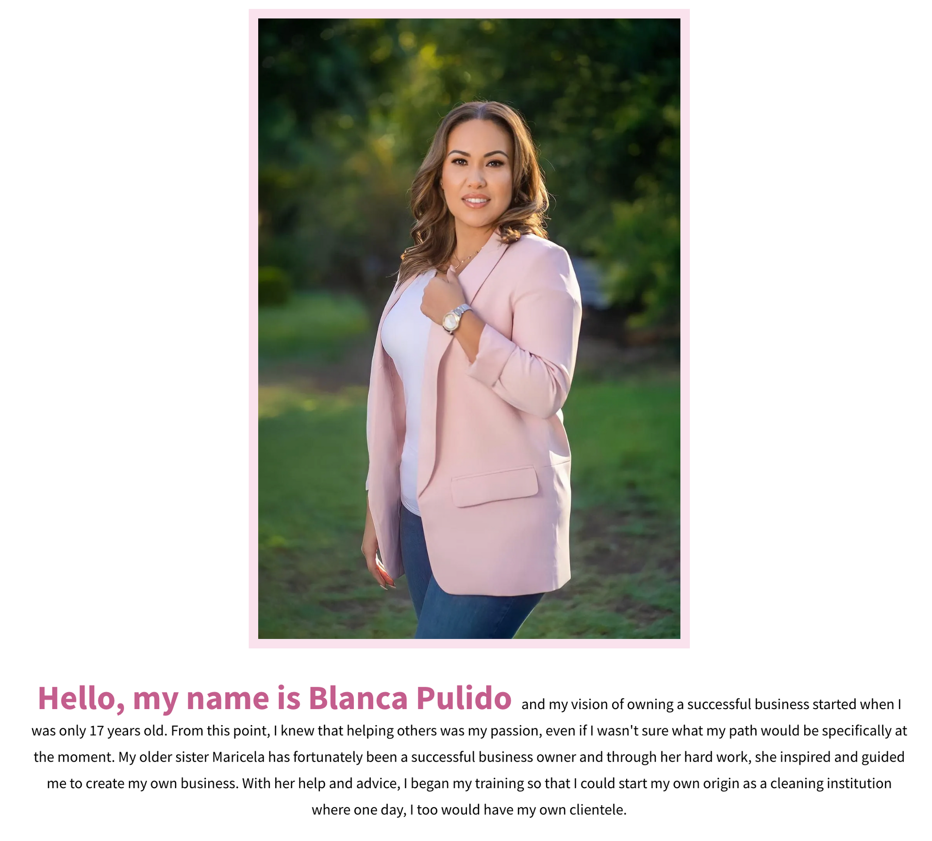 a woman in a pink jacket is standing in a field .