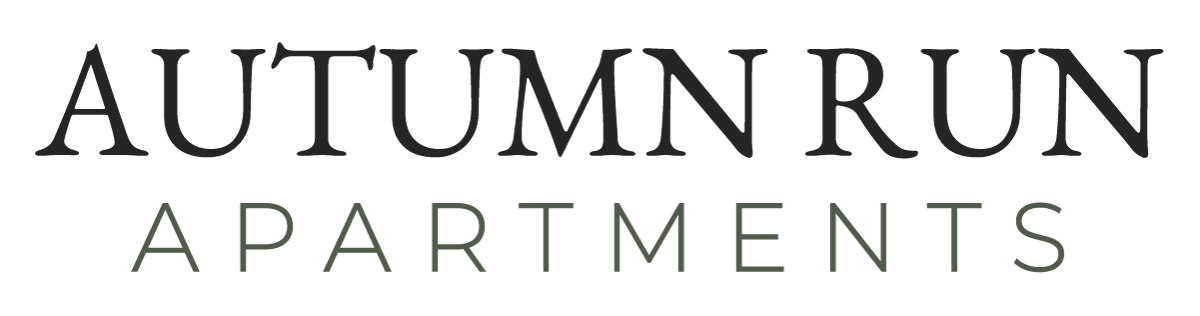 "AUTUMN RUN" in bold, dark font, "APARTMENTS" in a lighter, smaller font below it.