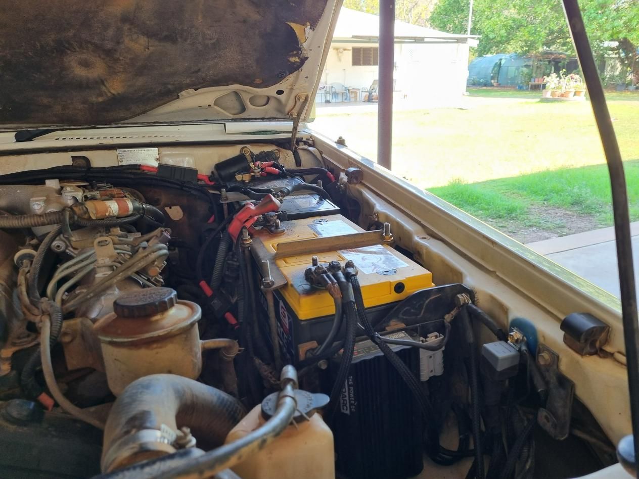 The Engine of A Car with The Hood Open and A Yellow Battery — D.J. Auto Electrics NT in Berrimah, NT