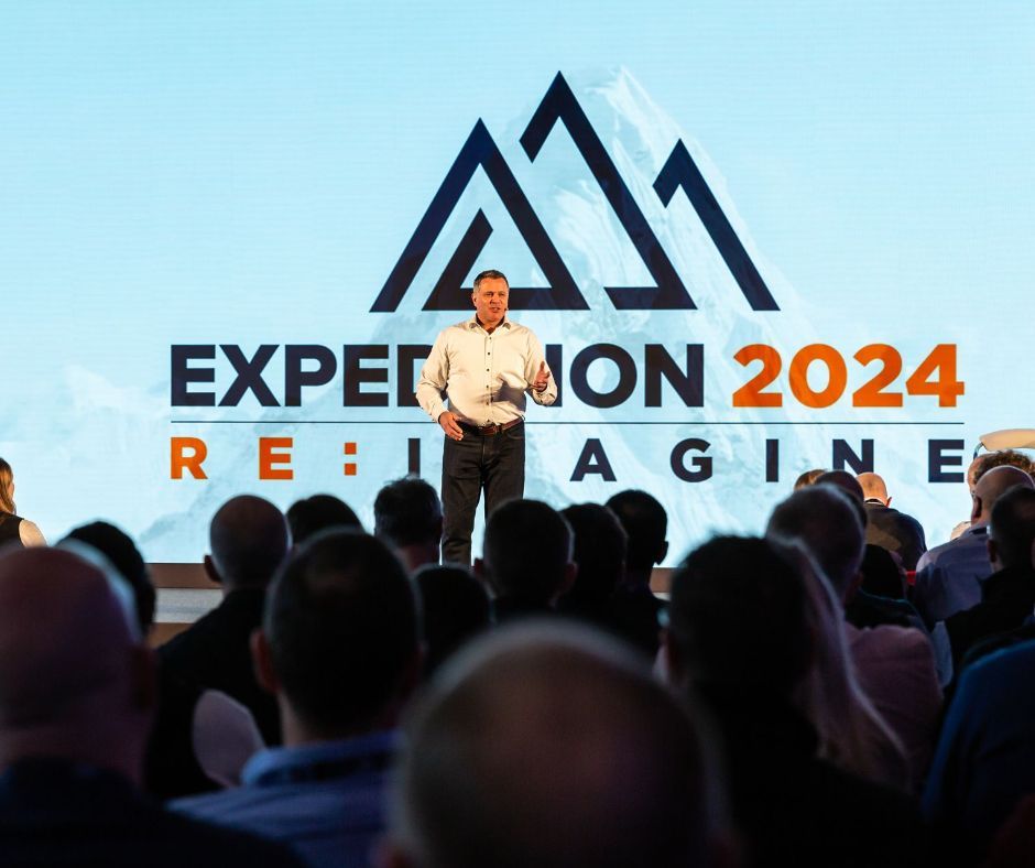 Man speaking on stage at 