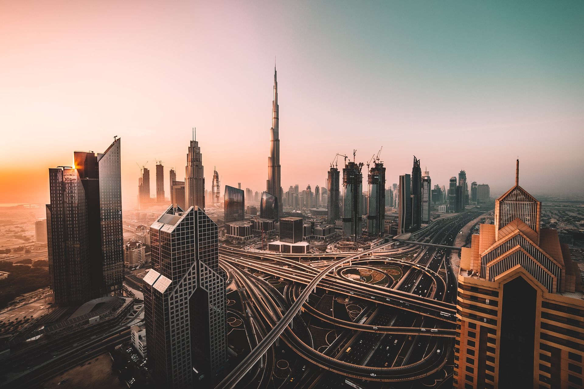 An aerial view of the skyline of dubai at sunset.