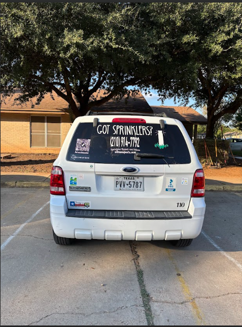 A white ford escape is parked in a parking lot