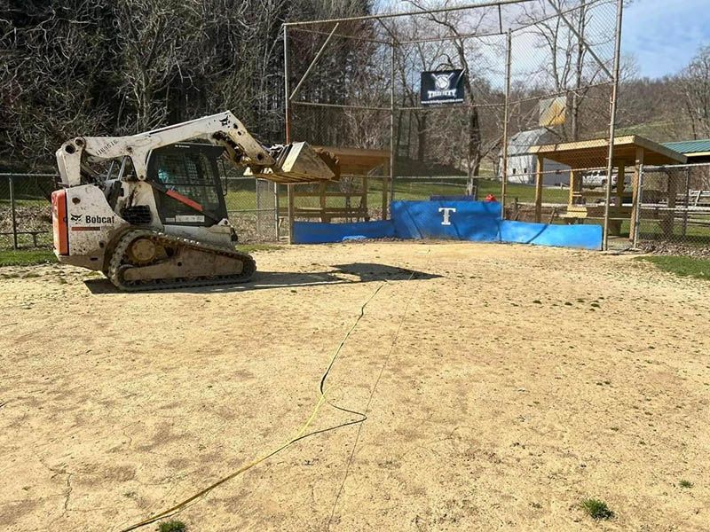 A bulldozer is sitting on top of a dirt field.