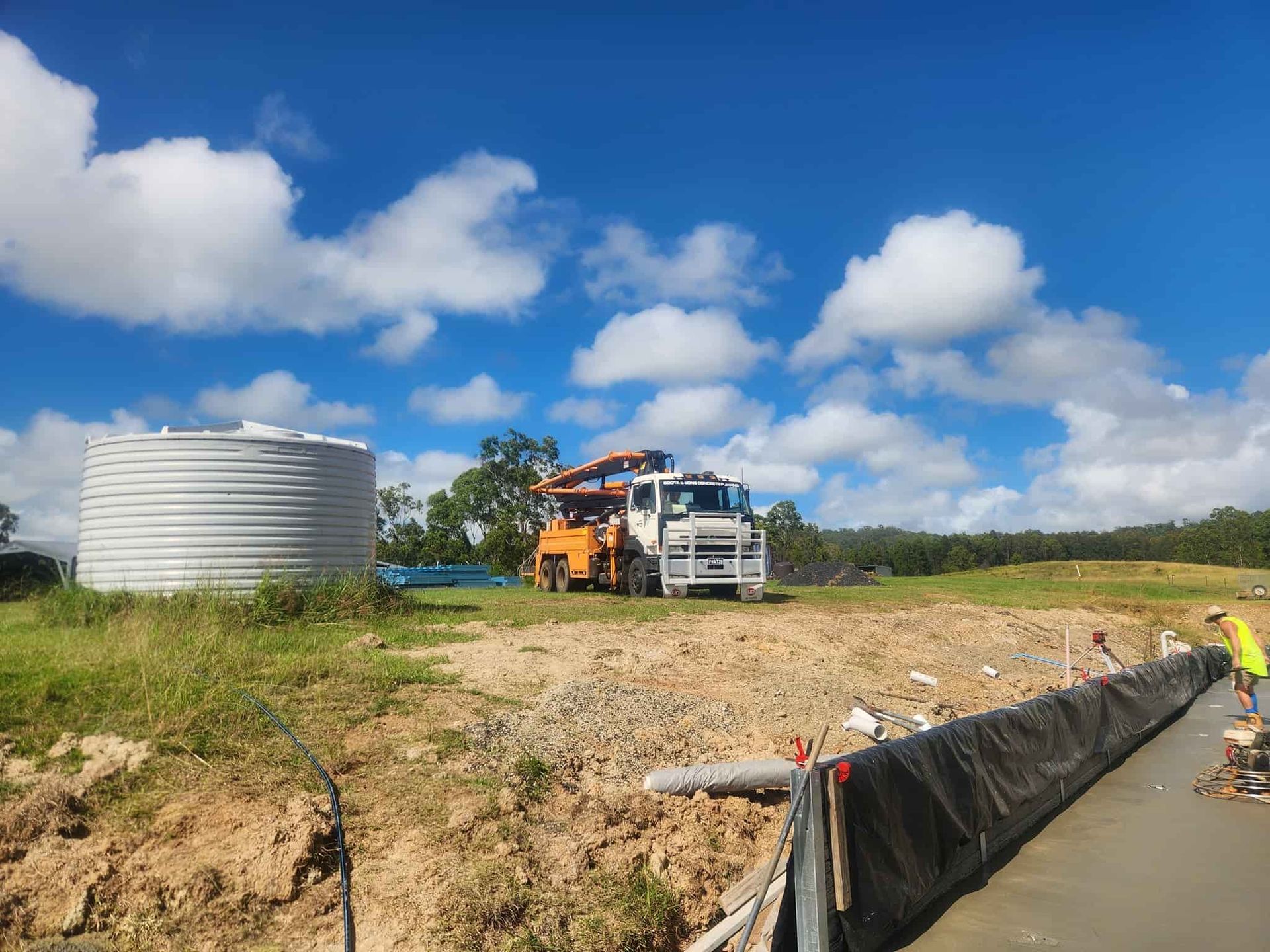 Construction Site With a Concrete Truck, Water Tank — Coota & Son's Concrete Pumping In Yamba, NSW