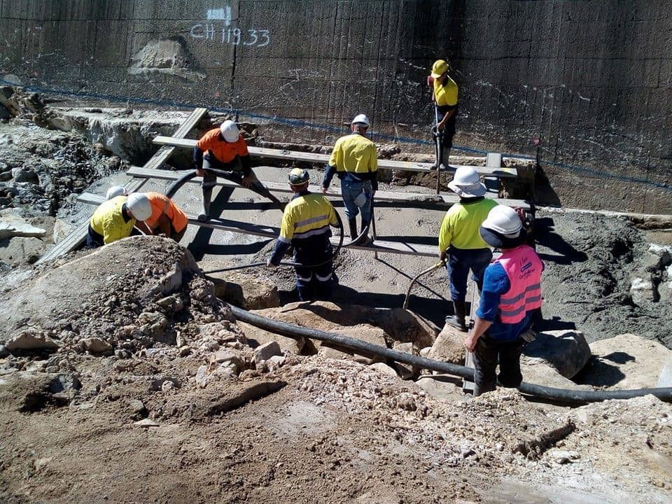 Construction Workers Wearing Safety Vests and Helmets — Coota & Son's Concrete Pumping In South Gundurimba, NSW