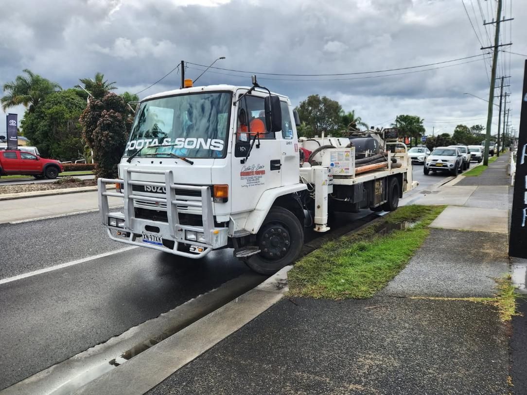 White Truck Parked on a Street Curb — Coota & Son's Concrete Pumping In South Gundurimba, NSW