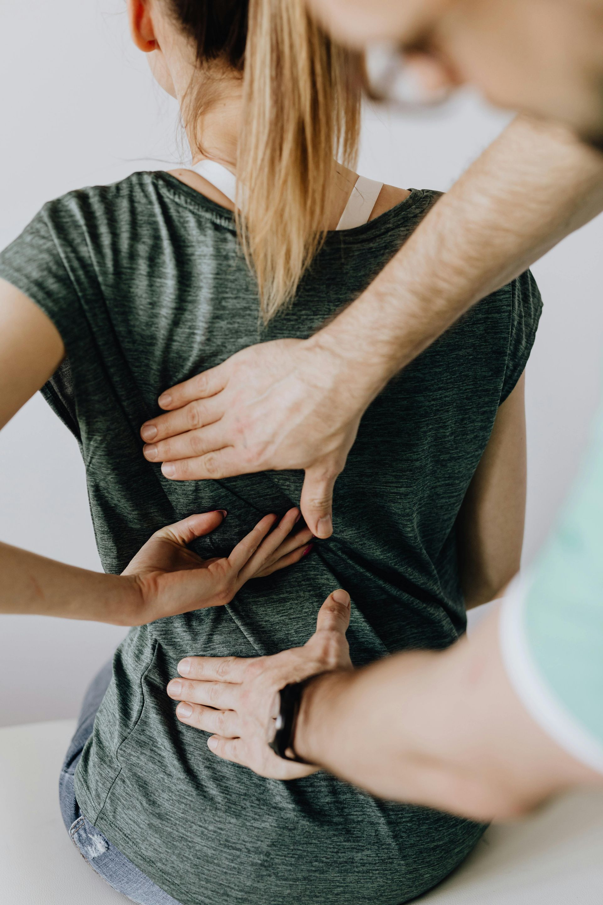 A man is giving a woman a massage on her back.