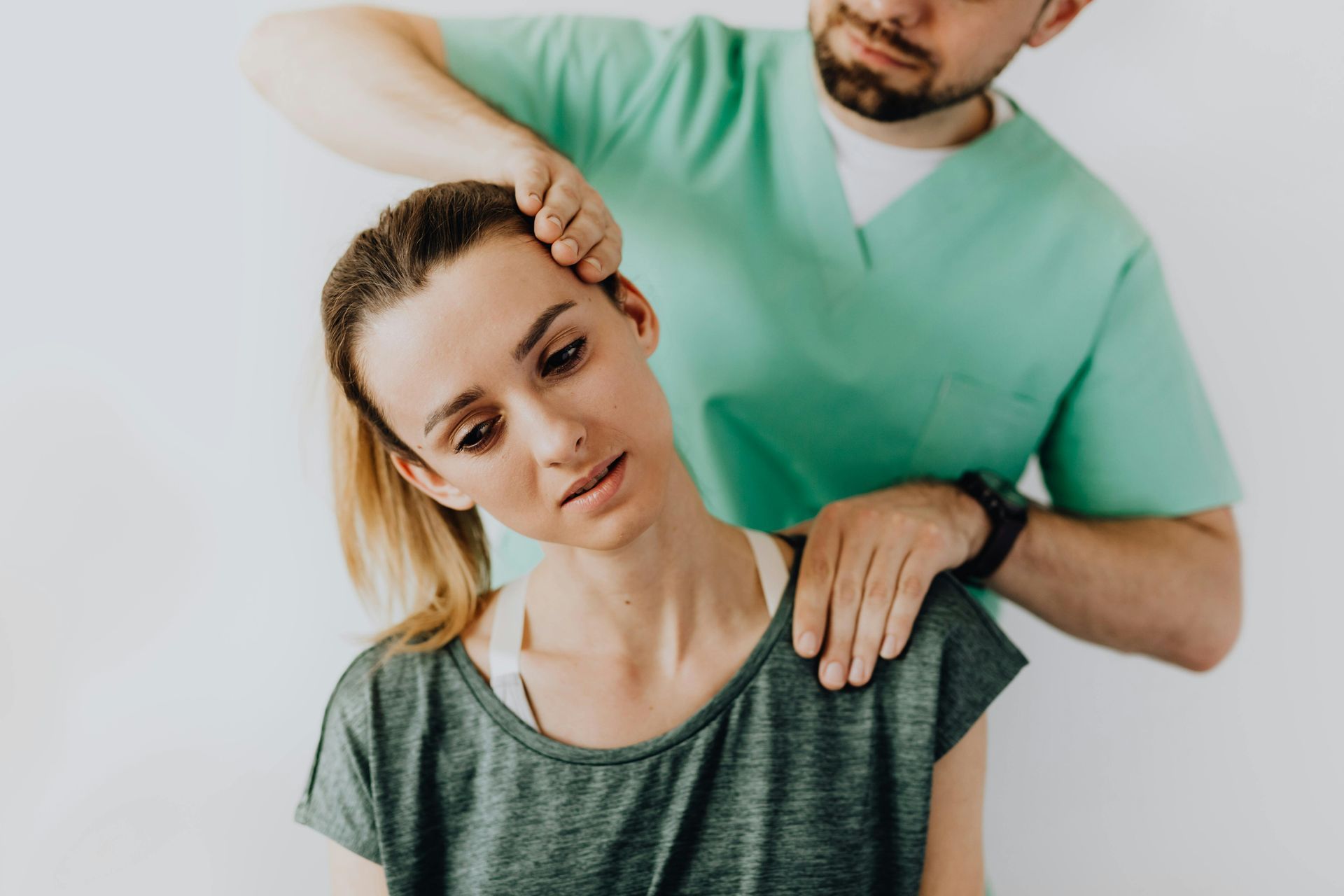 A man is giving a woman a neck massage.