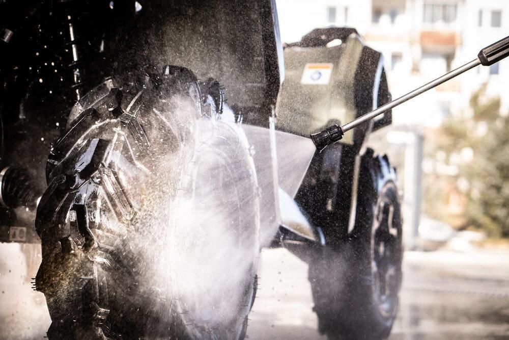 A Person Is Washing A Atv With A High Pressure Washer — JBS Mobile In Richmond Hill, NSW