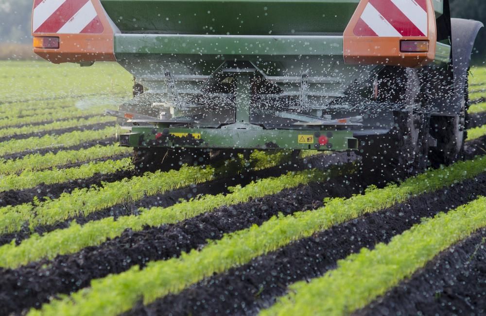 A Tractor Is Spraying Fertilizer On A Field Of Lettuce — JBS Mobile In Alstonville, NSW