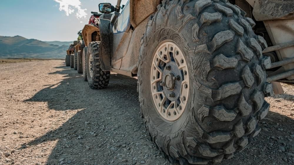 A Row Of Atvs Are Parked On A Dirt Road In The Desert — JBS Mobile In Ballina, NSW
