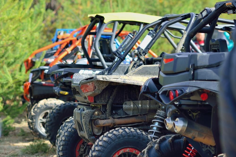 A Row Of Atvs Parked Next To Each Other On A Dirt Road — JBS Mobile In Richmond Hill, NSW