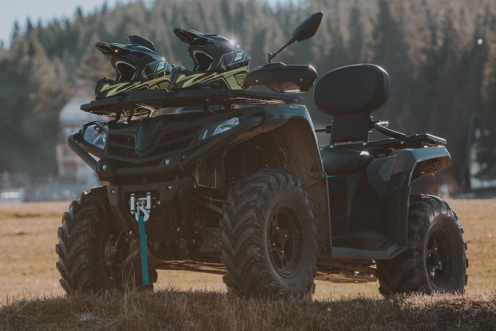 An Atv With Two Helmets On Top Of It Is Parked In A Field — JBS Mobile In Richmond Hill, NSW