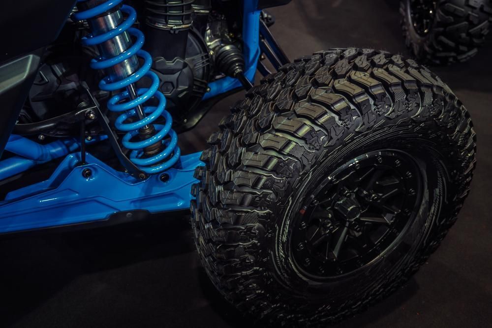 A Close Up Of A Tire On A Blue Atv — JBS Mobile In Richmond Hill, NSW