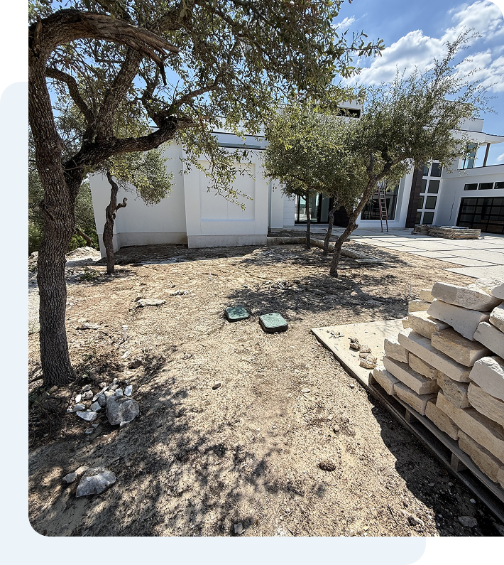 Brick landscaping next to a water sprinkler head.