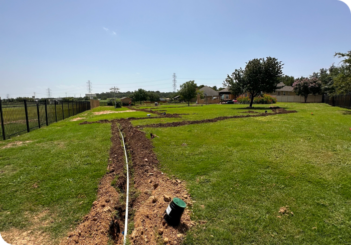 A white van with Texas Sprinkler Pro's written on the side is parked in front of a happy customers lawn.
