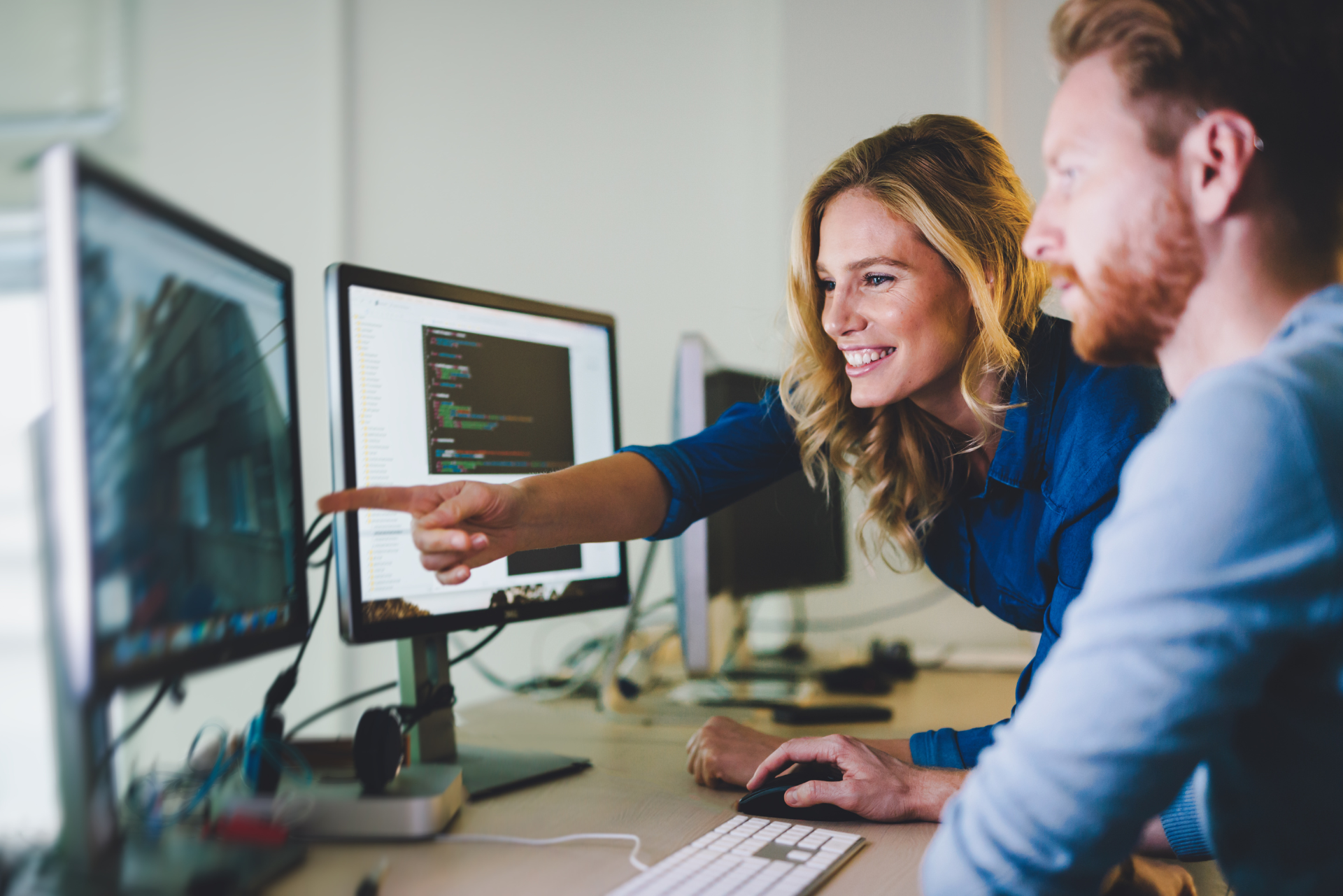 Un hombre y una mujer miran la pantalla de una computadora.