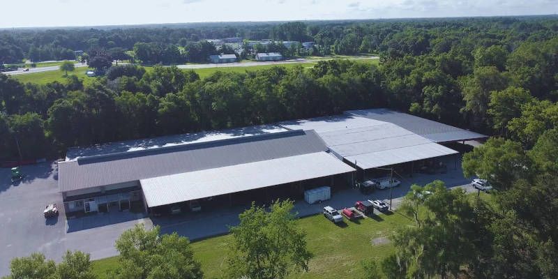 An aerial view of a large building surrounded by trees.
