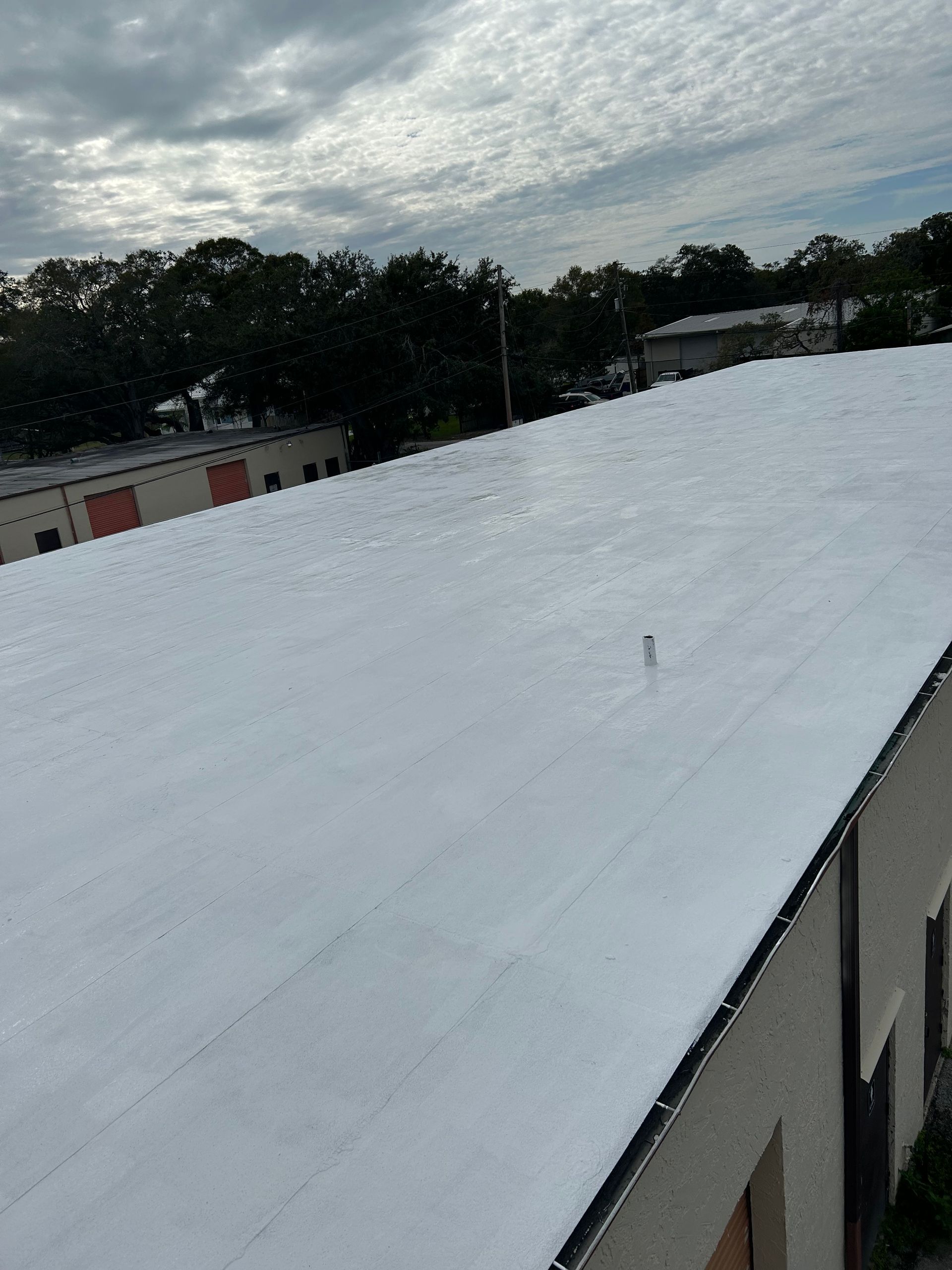 A silicone roof coating on a commercial flat roof in central Florida
