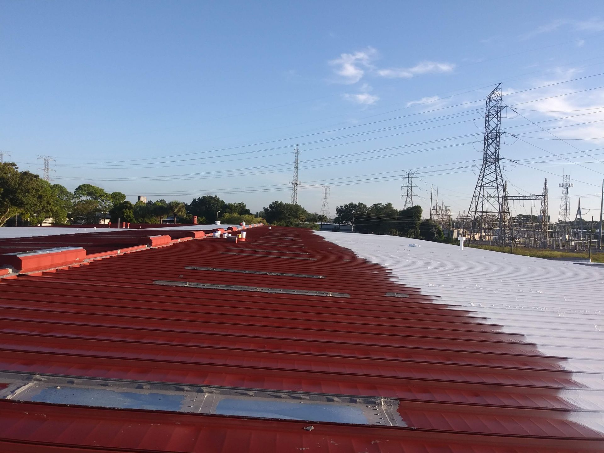 A red and white roof with a power line in the background.