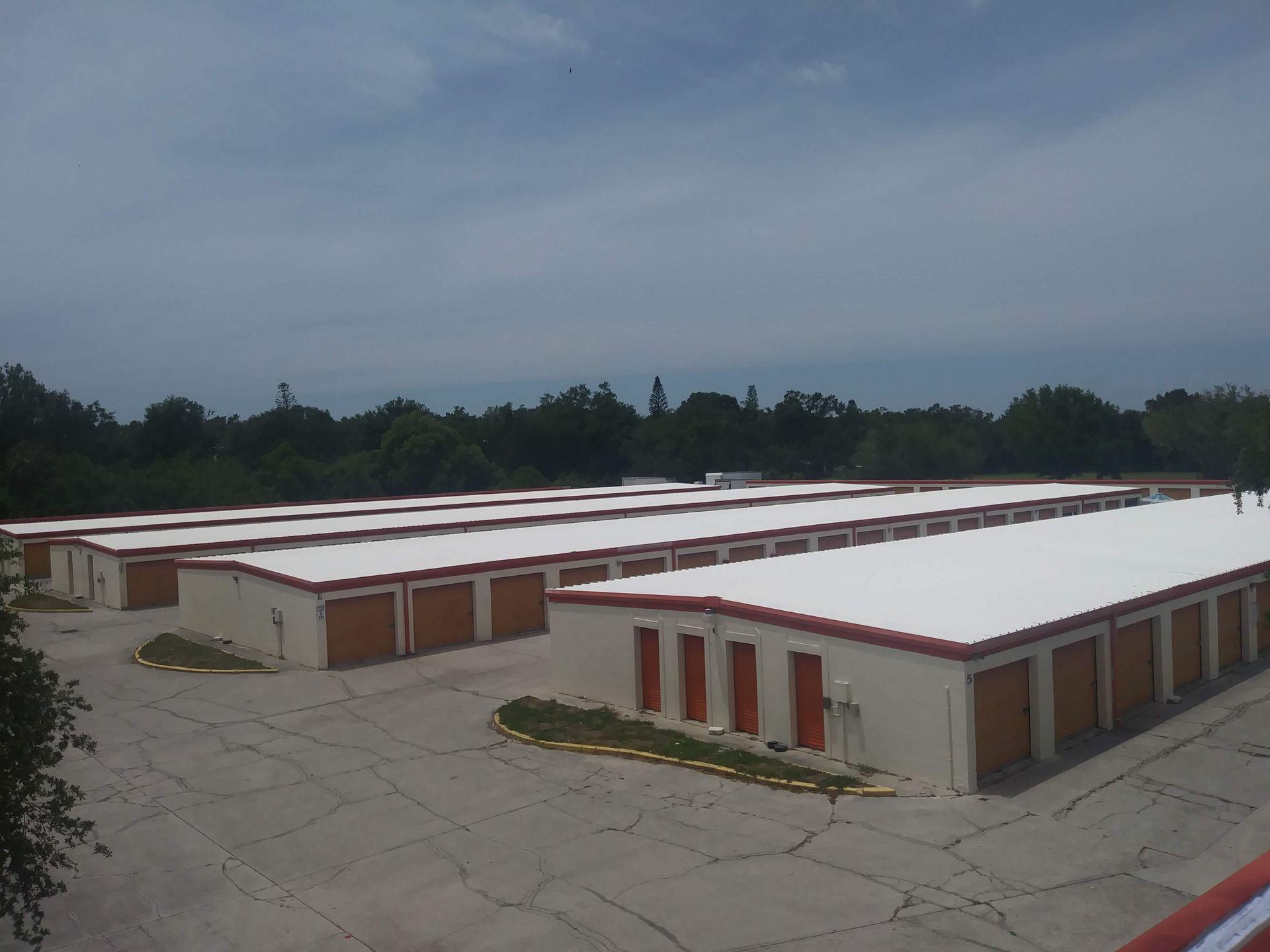A row of storage units with a white roof