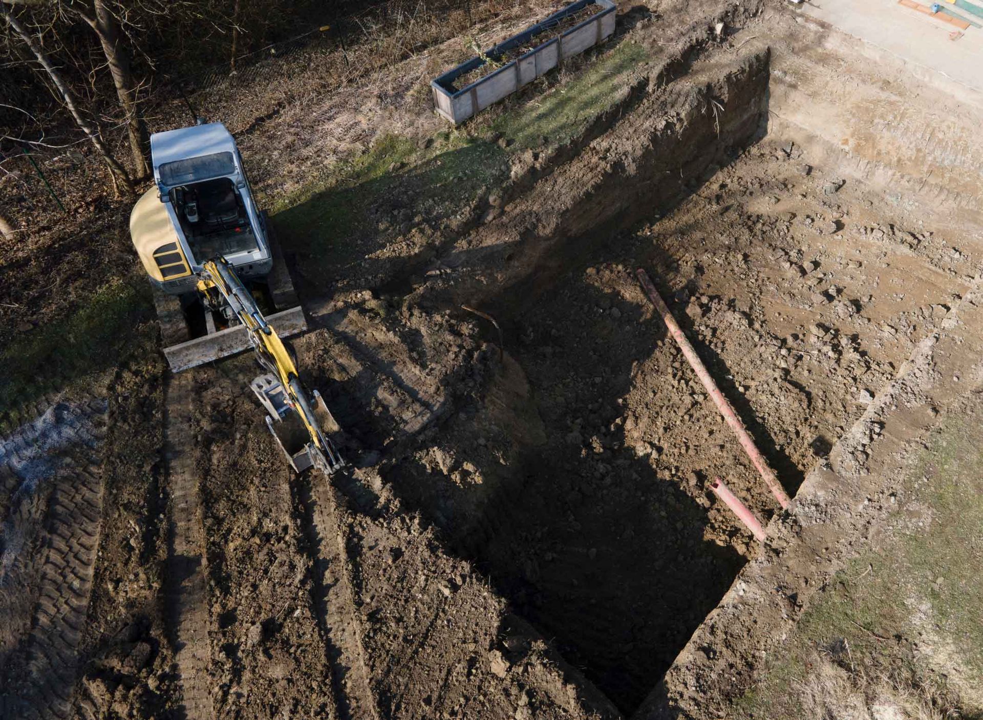 Overhead view of earthmoving equipment preparing the site for pool construction. Overhead view of earthmoving equipment preparing the site for pool construction.