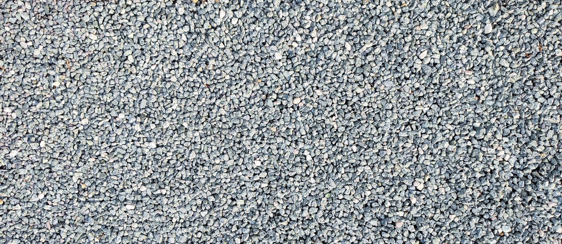 Close-up of gravel stones on the ground background, showcasing quarry materials. Close-up of gravel stones on the ground background, showcasing quarry materials.