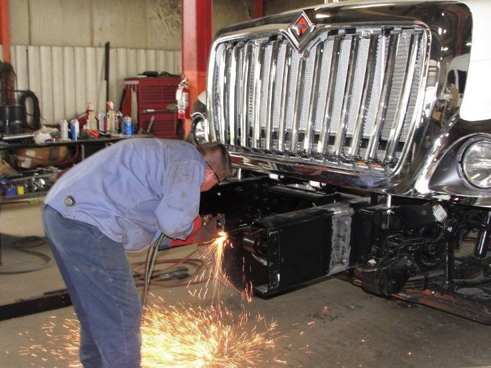 Truck Driver With Mask Checks The Correctness Of The Truck - Grove City, OH - Ace Truck Body Inc