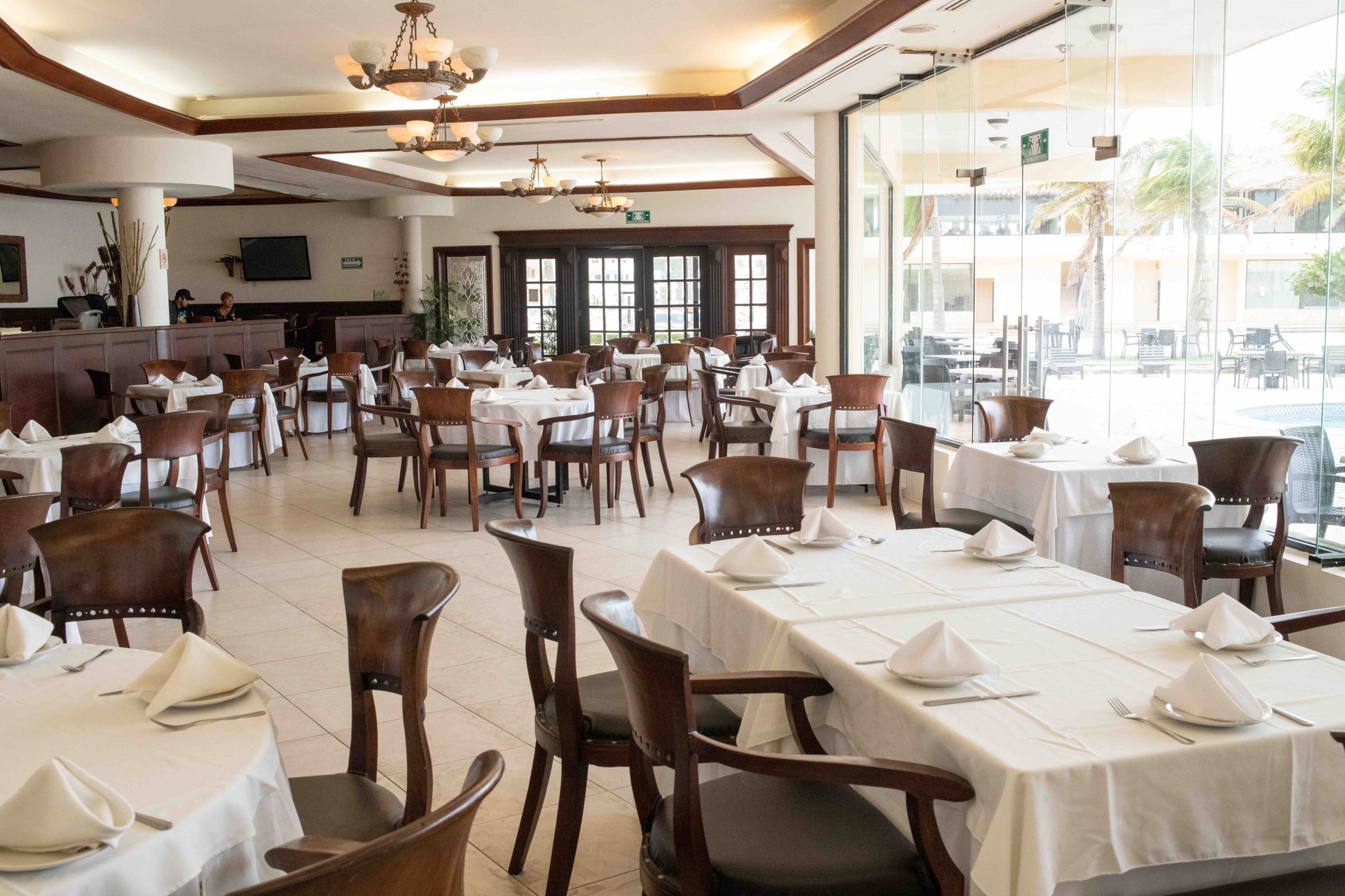 There are many tables and chairs in the restaurant.