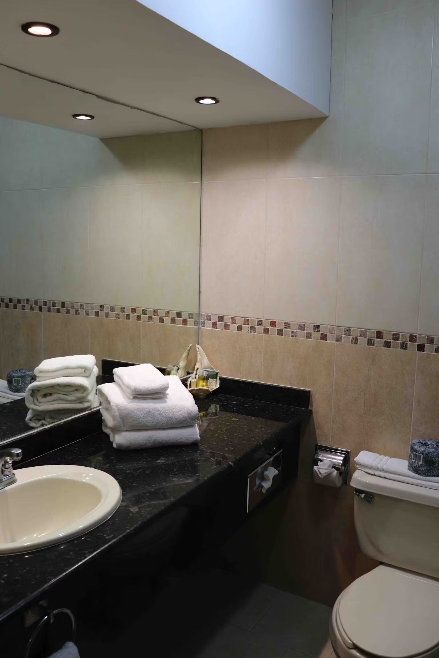 A bathroom with a sink , toilet and mirror