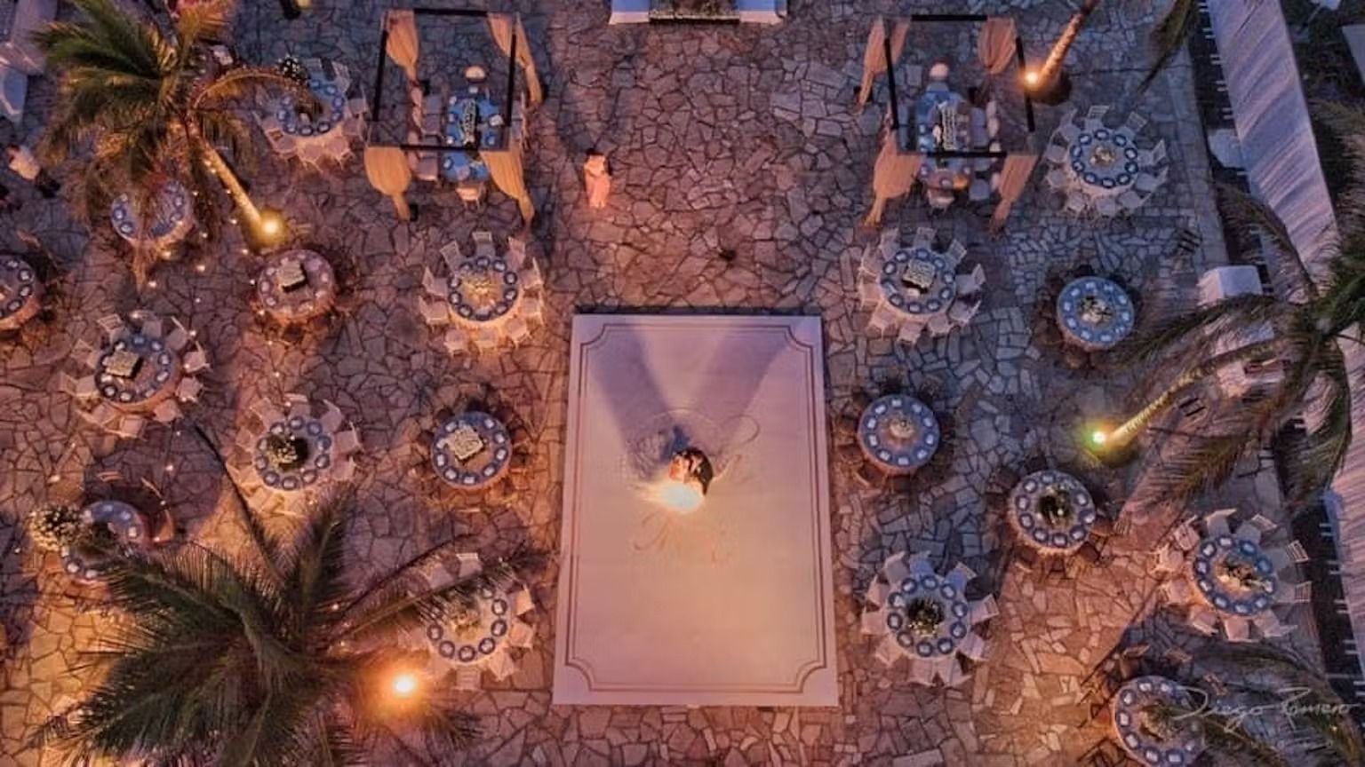 An aerial view of a wedding reception with tables and chairs.