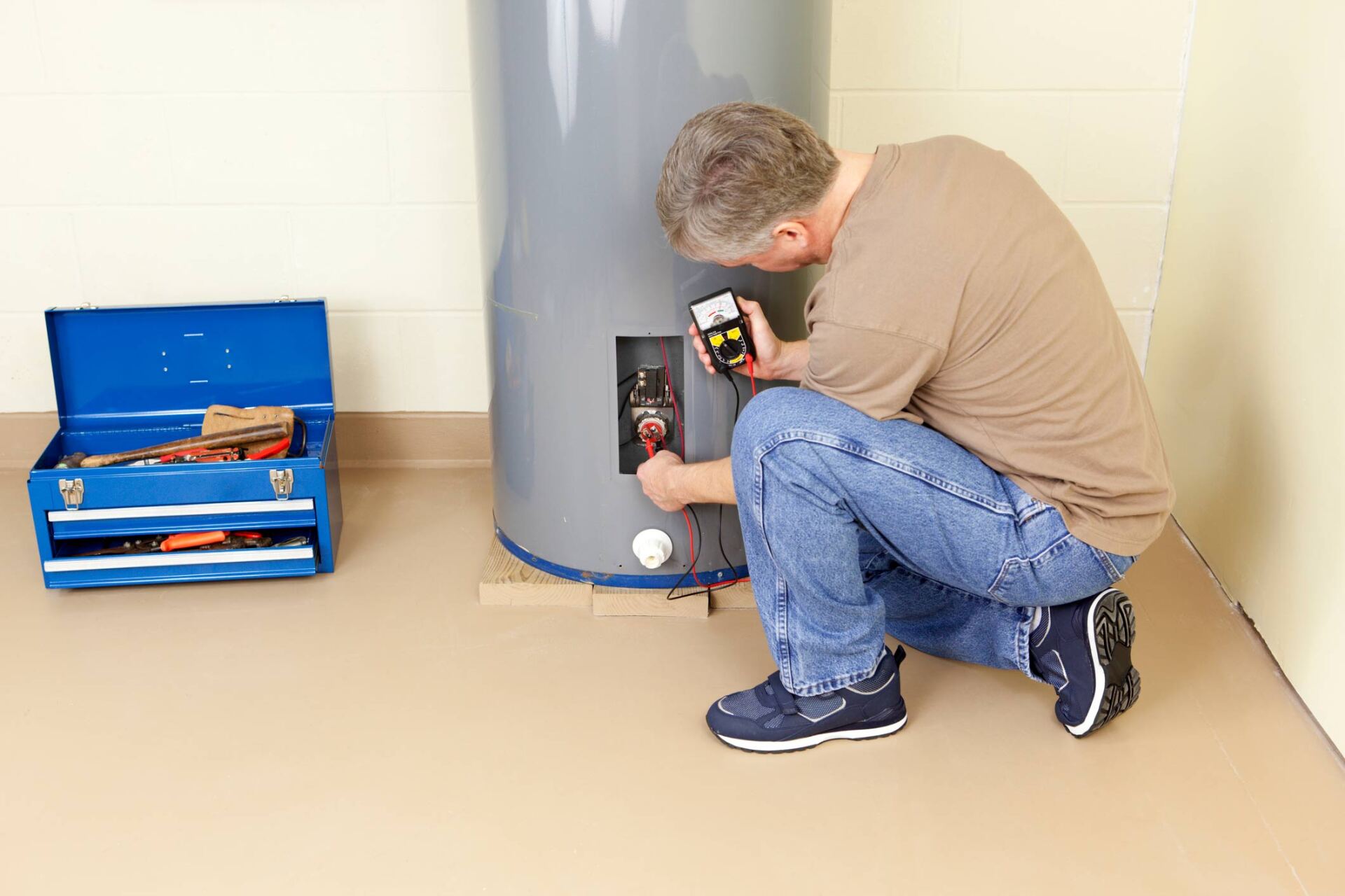 Plumber Testing Water Heater Element With Analog Multimeter — Fresno, CA — Kim's Plumbing
