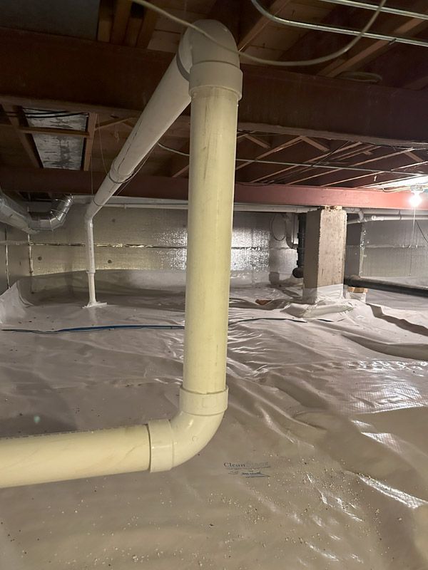 A basement with a lot of pipes coming out of it.
