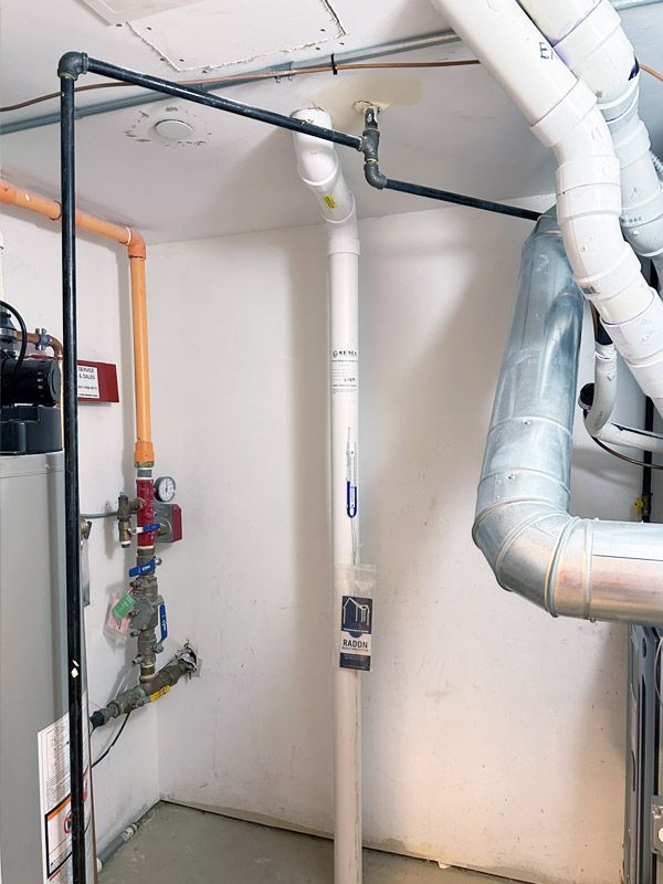 A room with a lot of pipes hanging from the ceiling.