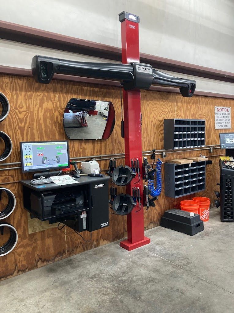 a computer is sitting on a desk in a garage next to a machine .
