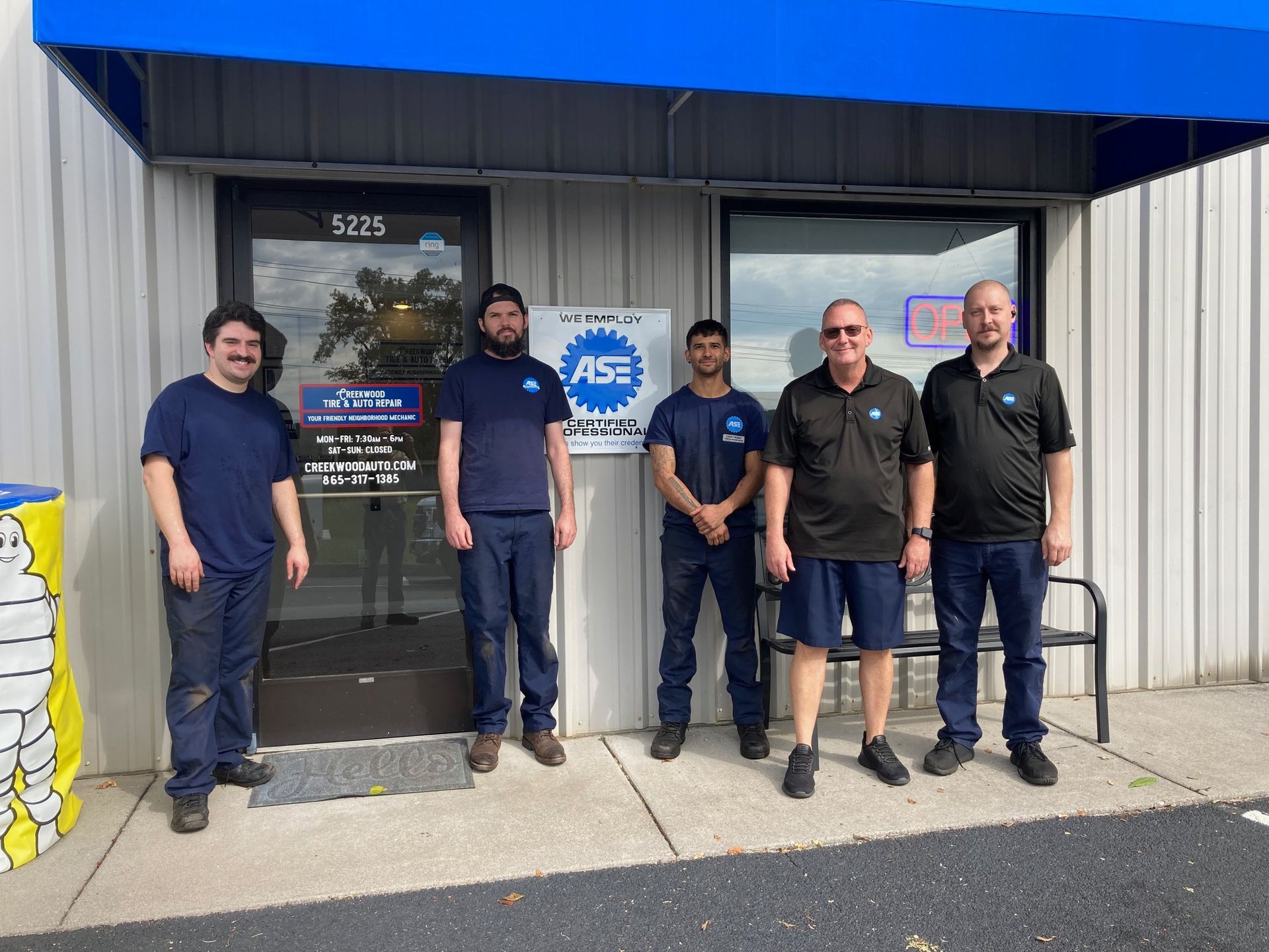 a group of men are standing in front of a building .