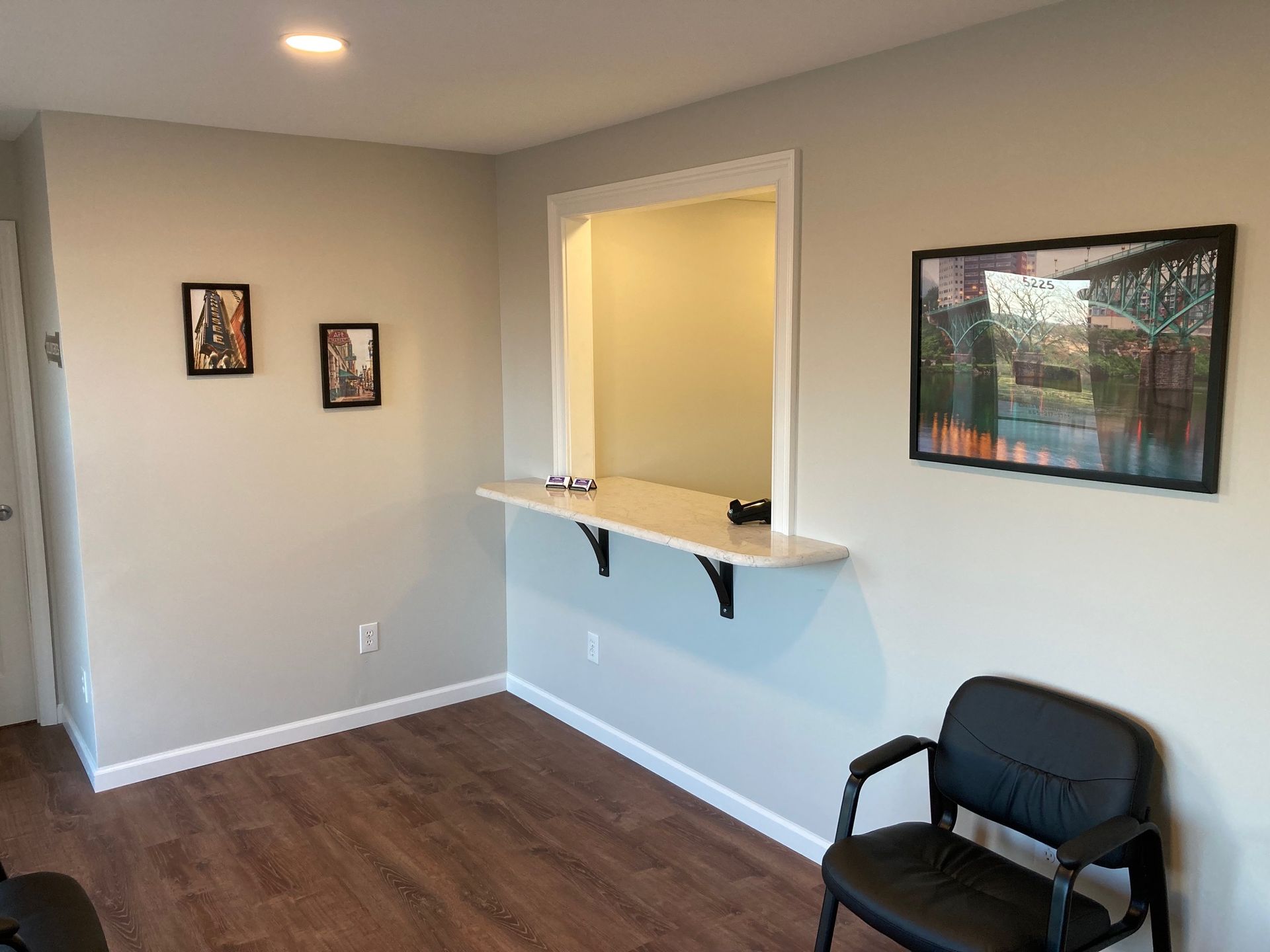 a waiting room with a chair and a window .