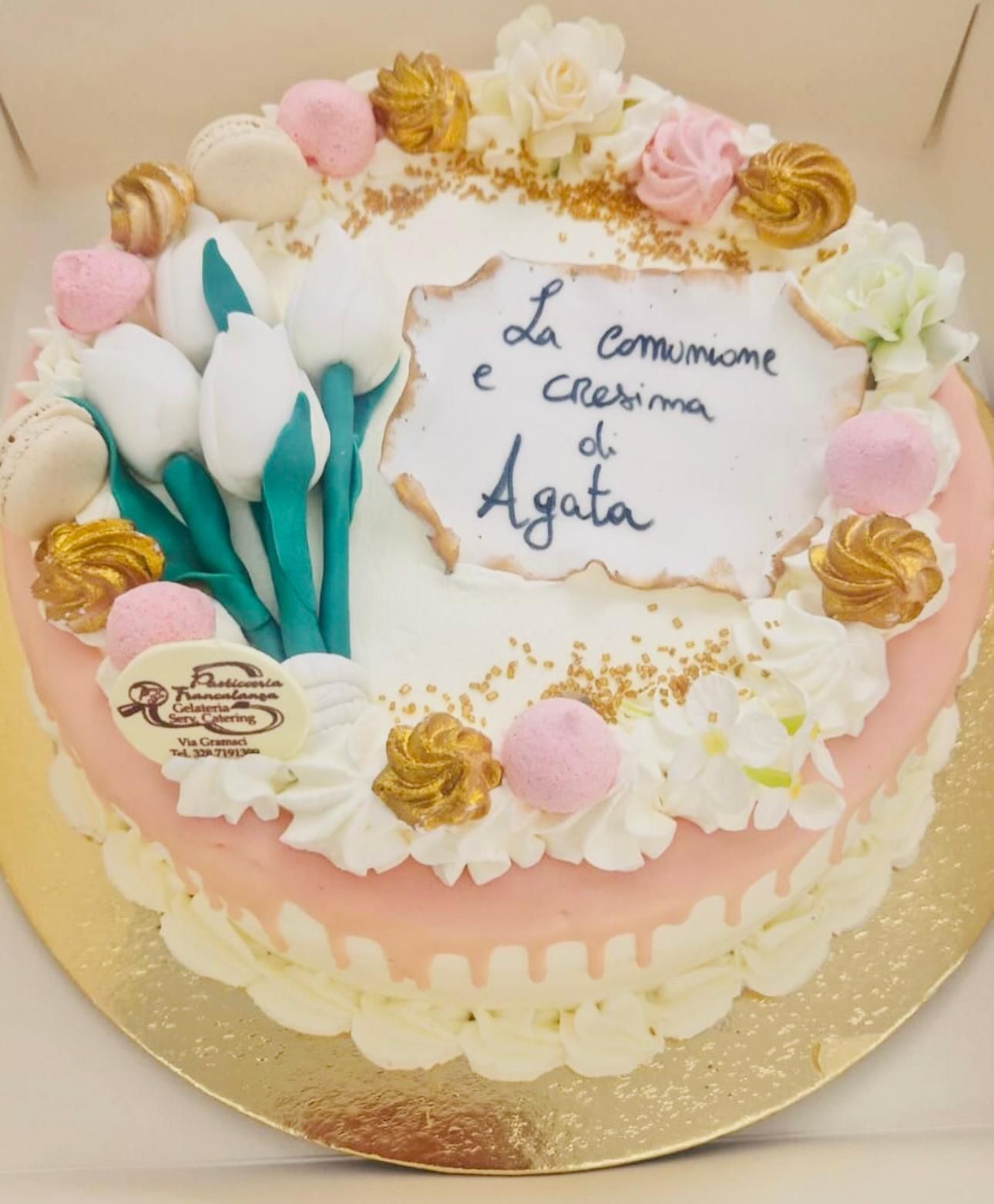 Cake decorated with flowers, tulips, frosting, and a message: