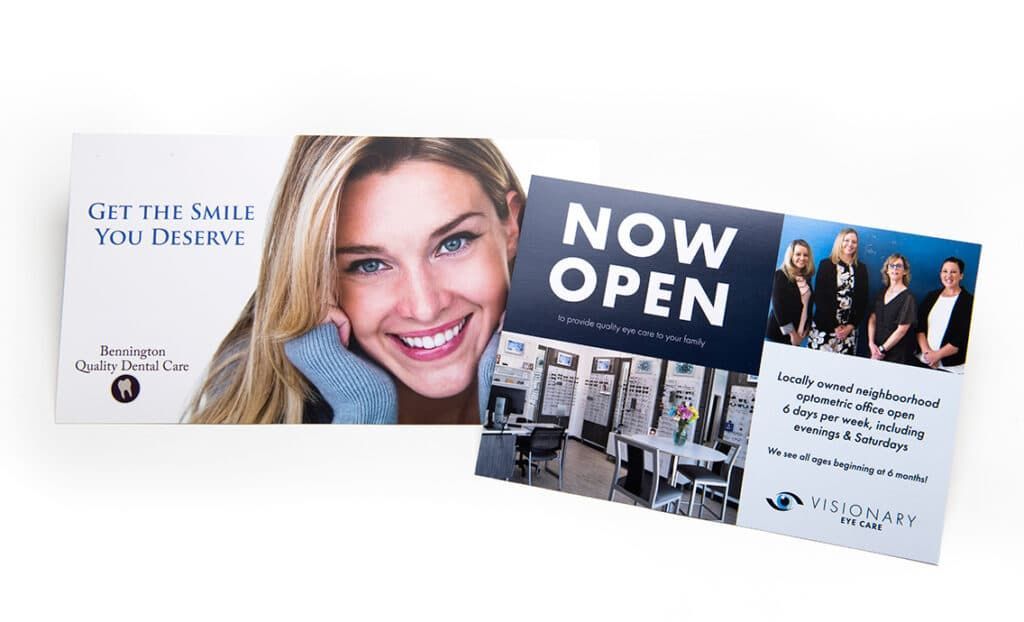 A woman is smiling on a card that says `` now open ''.