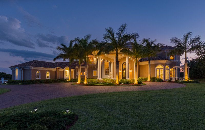 Beautiful image of large home with palm trees
