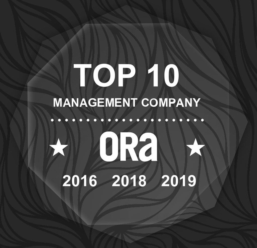 A glass plaque that says top 10 management company ora