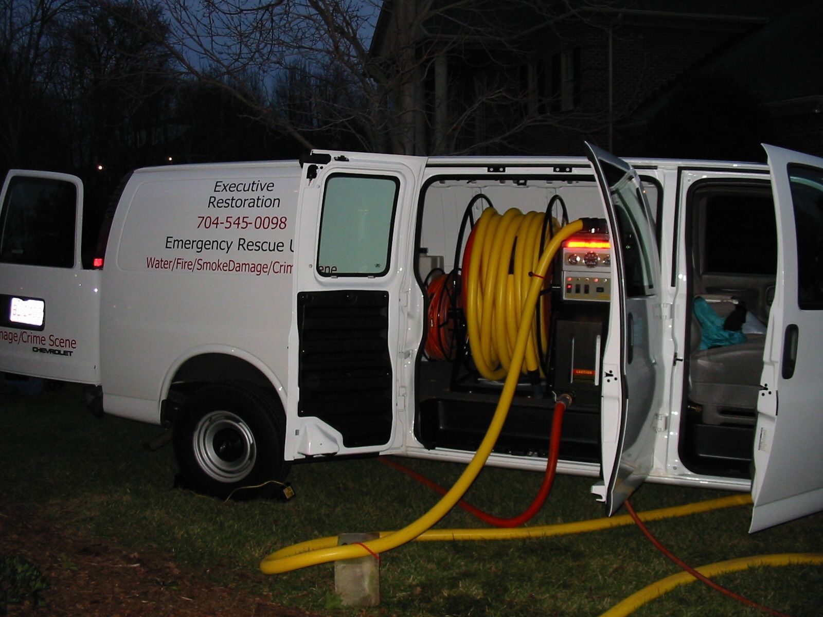 a white van with a yellow hose attached to it