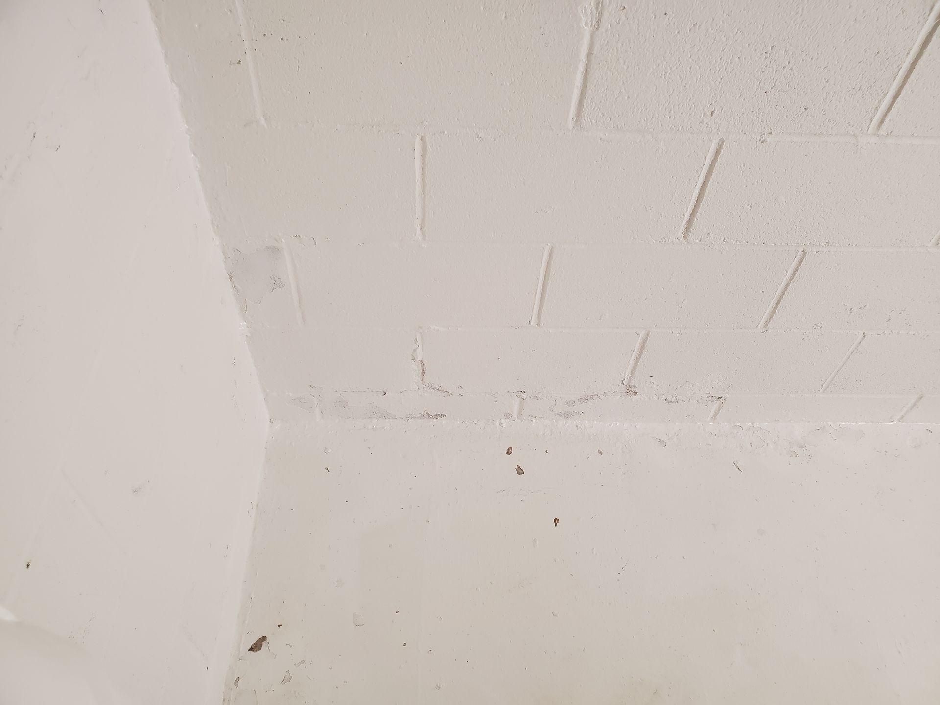 a close up of a dirty white wall with a ceiling