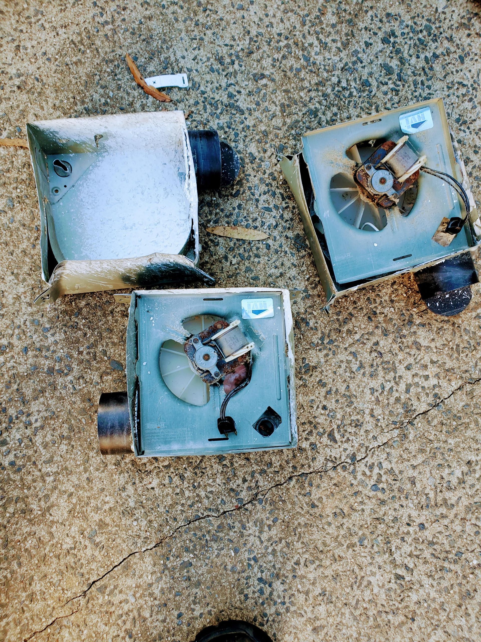 Three pieces of electrical equipment are laying on the ground